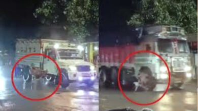 man sitting on chair in middle of road